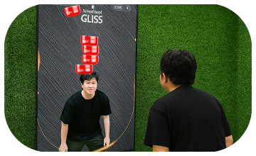 Guest playing interactive balance game using motion sensors to stack virtual items on head at a corporate event or exhibition booth in Dubai – fun and engaging activity.